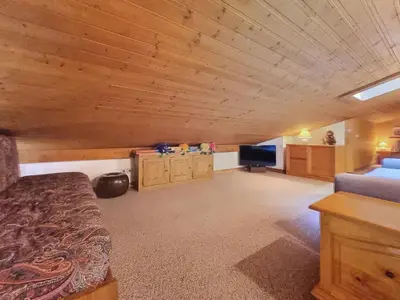 a large room with a bed and a television at Duplex 2 pièces avec balcon et Wifi face au Mont Blanc - FR-1-560-165 in Combloux