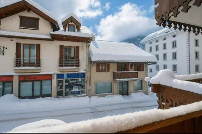a kitchen with a counter and a table with food on it at Cosy nest with balcony in the middle of Argentière in Chamonix-Mont-Blanc