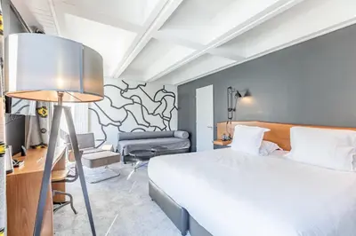 a living room with a couch and two windows at Totem, Friendly Hotel & Spa in Flaine
