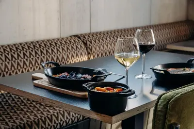 a hotel room with a bed and a desk at Totem, Friendly Hotel & Spa in Flaine