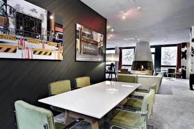 a dining room with a white table and chairs at Totem, Friendly Hotel & Spa in Flaine