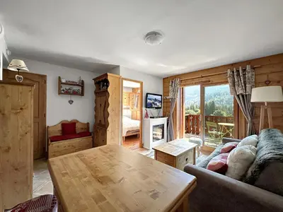 a living room with a couch and a table at TRAA15 Appartement 3 pieces proximite ski bus in Les Carroz d'Araches