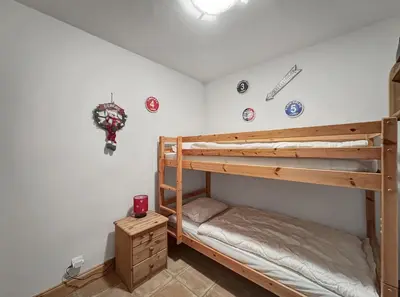 a bedroom with two bunk beds in a room at TRAA15 Appartement 3 pieces proximite ski bus in Les Carroz d'Araches