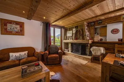 a living room with a couch and a fireplace at La Cachette - Mountain style and spacious 2-Bed apartment central Chamonix in Chamonix-Mont-Blanc