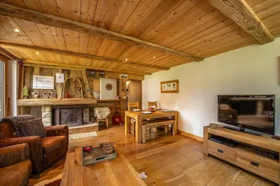 a living room with a couch and a tv at La Cachette - Mountain style and spacious 2-Bed apartment central Chamonix in Chamonix-Mont-Blanc