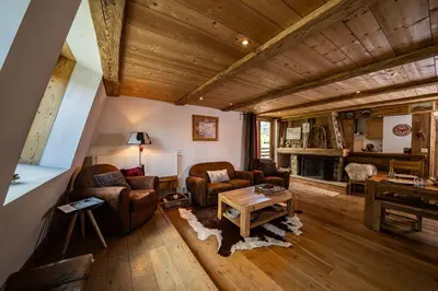 a living room with two couches and a piano at La Cachette - Mountain style and spacious 2-Bed apartment central Chamonix in Chamonix-Mont-Blanc