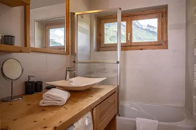 a bathroom with a sink and a bath tub at La Cachette - Mountain style and spacious 2-Bed apartment central Chamonix in Chamonix-Mont-Blanc