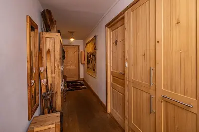 a hallway with wooden doors in a house at La Cachette - Mountain style and spacious 2-Bed apartment central Chamonix in Chamonix-Mont-Blanc