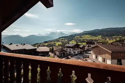 a view from a balcony of a town with mountains at Le Cocon - Balcon sur le Mont-Blanc in Combloux
