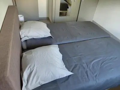 a bed with two pillows on it in a room at Maison La Pallud in Domancy