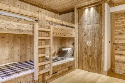 a wooden cabin with two bunk beds in it at Glacier in Megève