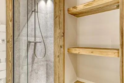 a bathroom with a shower with a glass door at Glacier in Megève