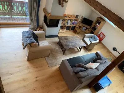 a living room with a couch and a table at Amazing Mt Blanc View 2 Bed, Parking, 10mins walk in Chamonix-Mont-Blanc