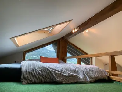 a bedroom with a bed with a large window at Amazing Mt Blanc View 2 Bed, Parking, 10mins walk in Chamonix-Mont-Blanc