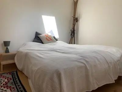 a white bed in a room with a window at Amazing Mt Blanc View 2 Bed, Parking, 10mins walk in Chamonix-Mont-Blanc