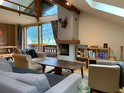 a living room with a couch and a coffee table at Amazing Mt Blanc View 2 Bed, Parking, 10mins walk in Chamonix-Mont-Blanc