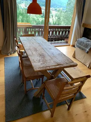 a wooden table and chairs in a living room at Amazing Mt Blanc View 2 Bed, Parking, 10mins walk in Chamonix-Mont-Blanc