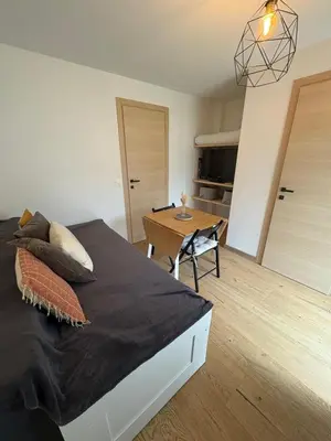 a bedroom with a large bed and a table at Chalet avec Jacuzzi vue Dômes de Miage in Bionnay