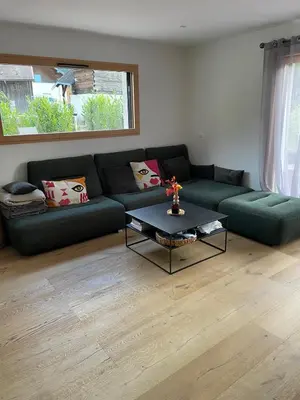 a living room with a couch and a coffee table at Chalet avec Jacuzzi vue Dômes de Miage in Bionnay