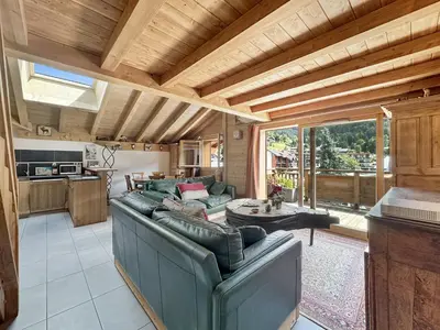a living room with couches and a kitchen at ELI422 Appartement standing 6 pers centre village in Les Carroz d'Araches