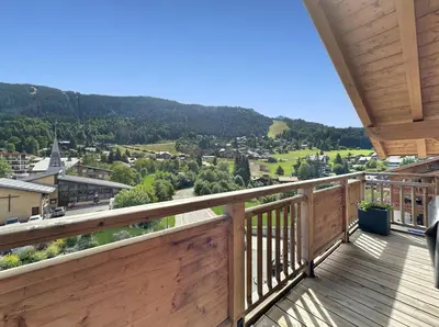 a balcony with a view of a town at ELI422 Appartement standing 6 pers centre village in Les Carroz d'Araches