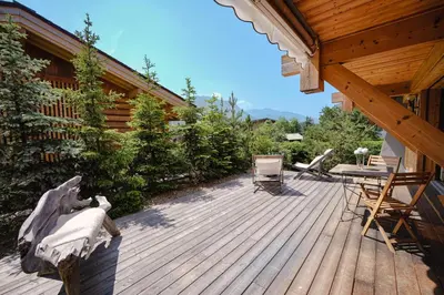 a living room with a couch and a fireplace at Chalet Merveille - Proche centre ville de Megève in Megève