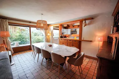a room with a bed and a table with a lamp at Chalet Merveille - Proche centre ville de Megève in Megève