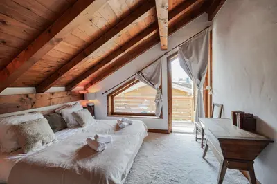 a bedroom with a desk and a bed and a table at Chalet Merveille - Proche centre ville de Megève in Megève
