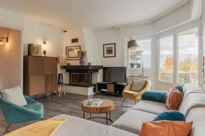 a living room with a couch and a fireplace at Le Montagny Sejour Cosy au Coeur des Alpes in Sallanches