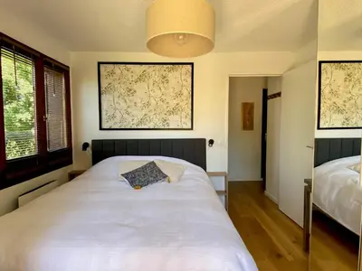 a bedroom with a white bed and a lamp at Le Sapin A5 in Megève