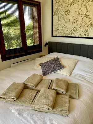 a white bed with four pillows on top of it at Le Sapin A5 in Megève