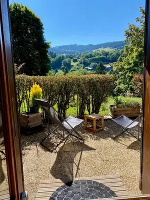 two chairs and a table on a patio at Le Sapin A5 in Megève