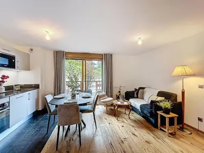 a living room with a couch and a dining room table at Charmant appartement à Combloux près des pistes avec parking - FR-1-560-166 in Combloux