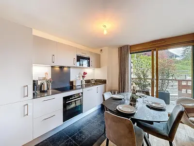 a kitchen and dining room with a table and chairs at Charmant appartement à Combloux près des pistes avec parking - FR-1-560-166 in Combloux
