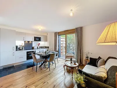 a living room with a couch and a table at Charmant appartement à Combloux près des pistes avec parking - FR-1-560-166 in Combloux
