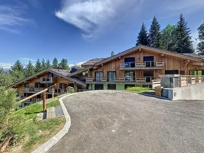 a large house with a road in front of it at Charmant appartement à Combloux près des pistes avec parking - FR-1-560-166 in Combloux