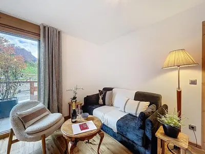 a living room with a couch and a chair at Charmant appartement à Combloux près des pistes avec parking - FR-1-560-166 in Combloux