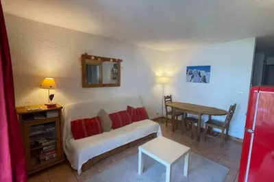a living room with a white couch and a table at Stay in the heart of Chamonix close to the slopes in Chamonix-Mont-Blanc