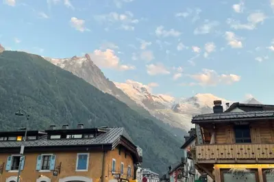 a city with buildings and mountains in the background at Stay in the heart of Chamonix close to the slopes in Chamonix-Mont-Blanc