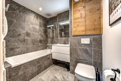 a bathroom with a toilet and a tub and a sink at Residence Blanc Mont Blanc in Chamonix-Mont-Blanc