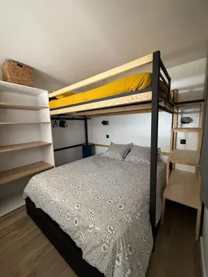 a bedroom with two bunk beds and a ladder at Appartement 1 chambre, balcon, vue montagne, aux pieds des pistes in Les Houches