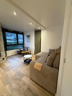 a living room with a couch and a table at Appartement 1 chambre, balcon, vue montagne, aux pieds des pistes in Les Houches