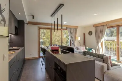 a kitchen and living room with a couch at Blanc Mont Blanc in Chamonix-Mont-Blanc