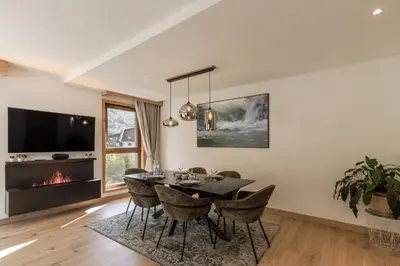 a dining room with a table and chairs and a fireplace at Blanc Mont Blanc in Chamonix-Mont-Blanc
