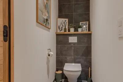 a bathroom with a toilet and a shelf with plants at Blanc Mont Blanc in Chamonix-Mont-Blanc