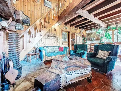 a living room with blue chairs and a table at Apartment Chalet le Prarion by Interhome in Saint-Gervais-les-Bains