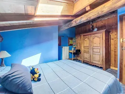 a blue bedroom with a bed with two teddy bears on it at Apartment Chalet le Prarion by Interhome in Saint-Gervais-les-Bains