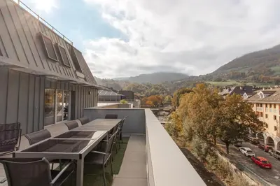 a balcony with a table and chairs overlooking a city at Le Méribel - Terrasse 83m2 - Vue Mont-Blanc in Sallanches