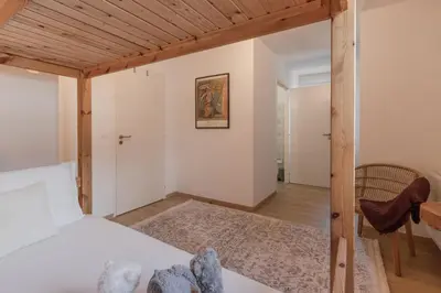 a bedroom with a bed and a table and a chair at Le Méribel - Terrasse 83m2 - Vue Mont-Blanc in Sallanches