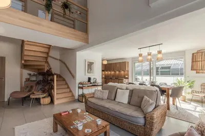 a living room with a couch and a table at Le Méribel - Terrasse 83m2 - Vue Mont-Blanc in Sallanches